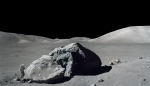Schmitt is photographed standing next to a huge split lunar boulder.jpg